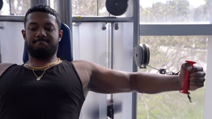 Alfin Jeyaseelan working out at a weight machine.