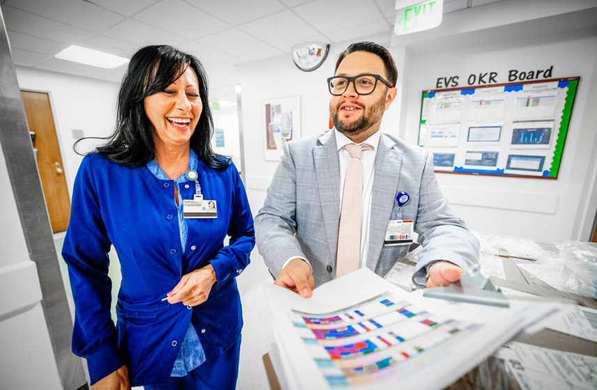 Two Cleveland Clinic caregivers smiling while having a conversation.