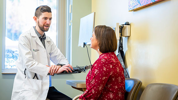 Doctor sitting with a patient for a general examination.