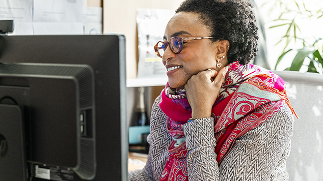 Woman smiling at computer