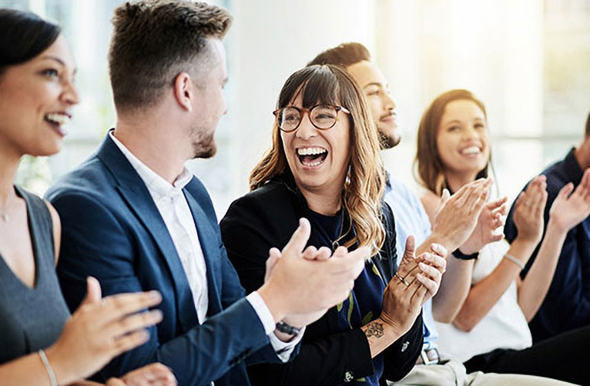 Office workers clapping and cheering.