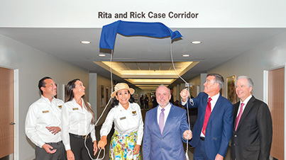 An image of the ribbon-cutting ceremony for the Rita and Rick Case Corridor.