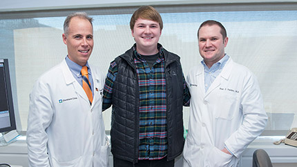 Cleveland Clinic patient posing with his two facial reconstruction surgeons